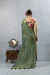 A full back view of the model in the Vanya Sarees ensemble, displaying the drape of the tissue silk pallu and the artistic appliqué blouse.