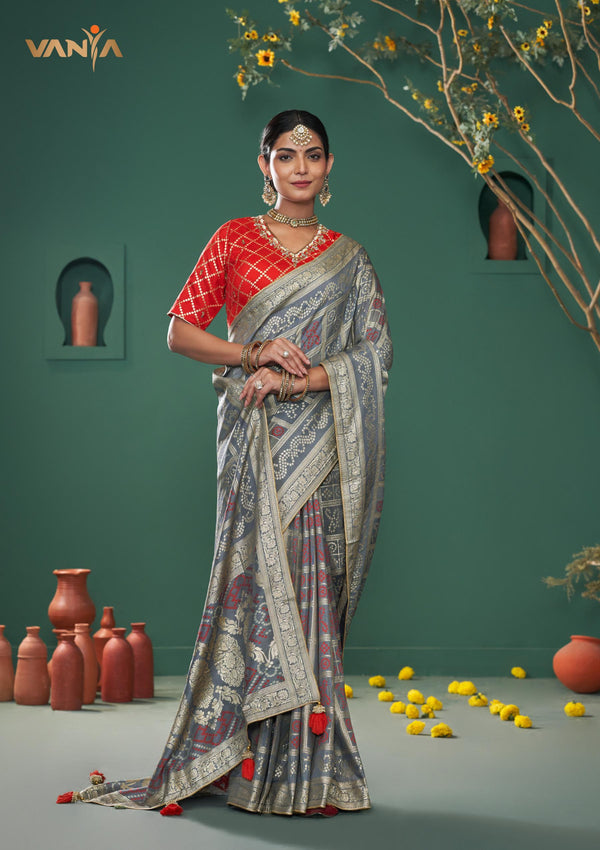 An elegant standing pose of the model showcasing the complete designer look of the Vanya Sarees grey Patola weave Banarasi saree.