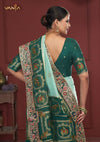 The magnificent, heavy embroidered pallu of the Vanya Sarees bridal saree, showcasing the intricate peacock and elephant motifs.