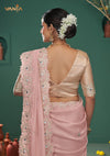 The stunning back view of the Vanya Sarees ensemble, showcasing the heavy mirror work border on the pallu and the deep V-back of the gold blouse.