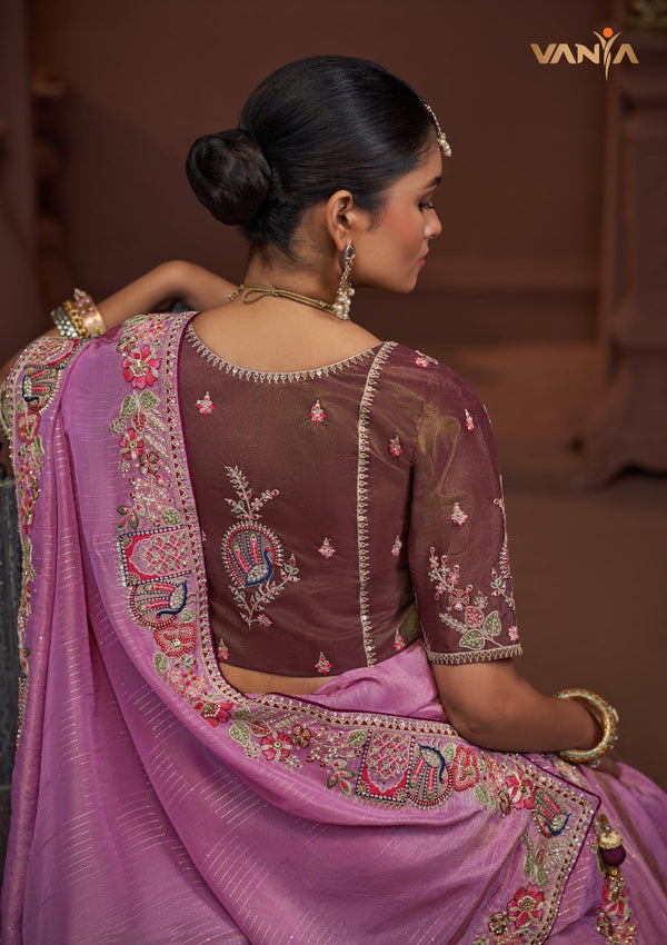 The elegant back view of the Vanya Sarees ensemble, showcasing the heavy embroidery on the pallu and the designer back of the plum blouse.