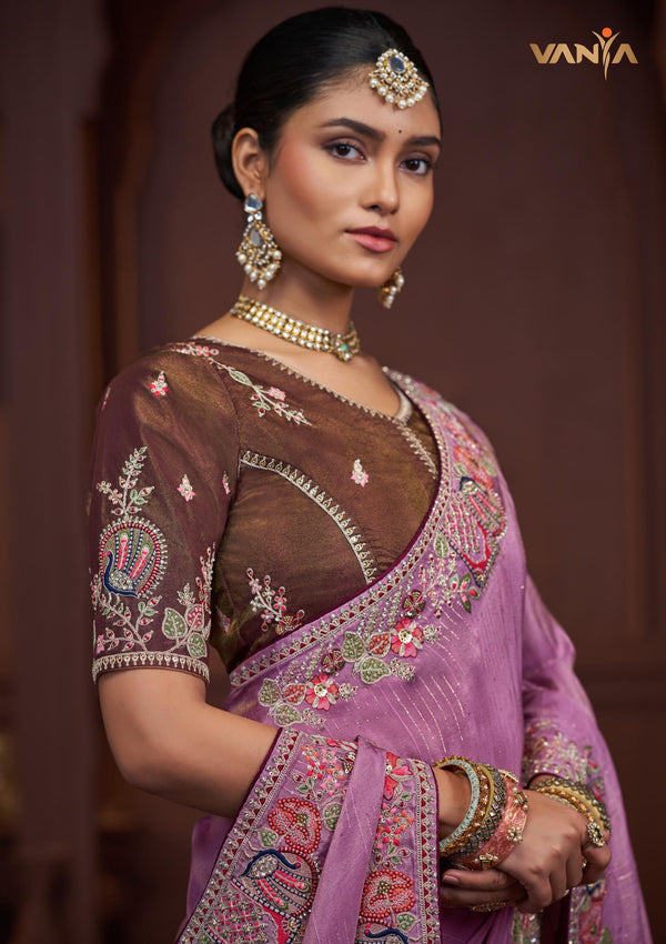 A stunning close-up of the model wearing the Vanya Sarees lavender saree, showing the intricate multi-color embroidery on the border and blouse sleeve.