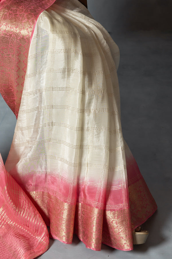 A detailed shot of the Vanya Sarees fabric, highlighting the woven gold zari check pattern on the ivory tissue silk.