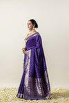 A beautiful side profile of the model wearing the Vanya Sarees purple Katan silk saree, showing its rich texture and drape.