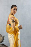 A detailed side profile of the model in a Vanya Sarees saree, showing the unique 3D puppet and printed motif on the designer blouse sleeve.