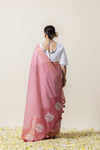 A full back view of the model in the Vanya Sarees ensemble, highlighting the Leheriya print pallu and the mirror work on the U-back of the blouse.
