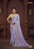 A full-length view of the model in Vanya Sarees' magnificent lavender silk saree with a heavy, multi-color embroidered border and yellow blouse.