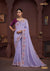 A full-length view of the model in Vanya Sarees' magnificent lavender silk saree with a heavy, multi-color embroidered border and plum blouse.
