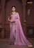 A full-length view of the model in Vanya Sarees' magnificent lavender silk saree with a heavy, multi-color embroidered border and plum blouse.