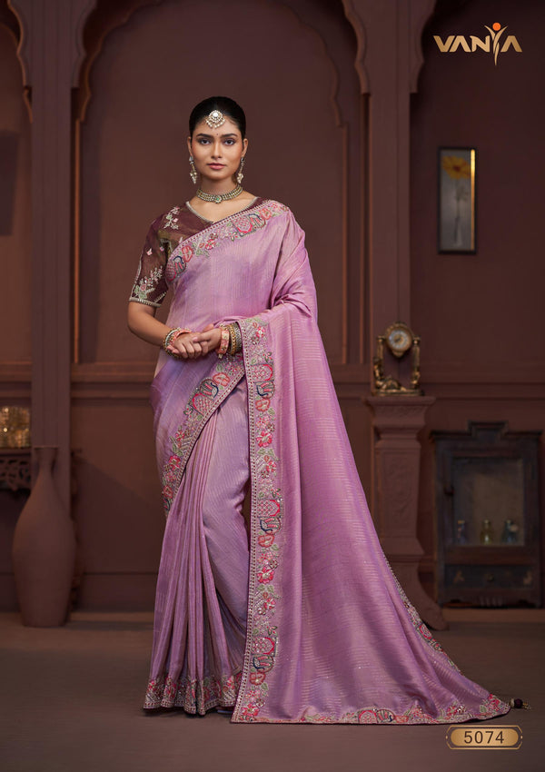 A full-length view of the model in Vanya Sarees' magnificent lavender silk saree with a heavy, multi-color embroidered border and plum blouse.