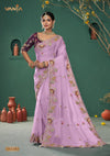 A full-length view of the model in Vanya Sarees' magnificent lilac silk saree with a heavy, multi-color embroidered border and plum blouse.