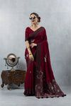 Vanya Maroon Saree in a cheerful side pose, emphasizing the beautiful metallic shine and flowing drape of the fabric.