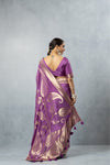 Back view of a model in a Vanya Sarees mauve designer saree, displaying the deep V-neck blouse and the rich zari work on the pallu.