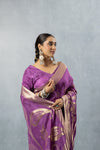 Close-up shot of the Vanya Sarees mauve saree, showing the texture of the tissue silk fabric and the intricate antique gold border over the model's shoulder.