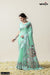 A full-length view of the model in Vanya Sarees' artistic mint green linen silk saree with a unique figurative print.