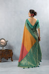 A full back view of the model in the Vanya Sarees ensemble, displaying the drape of the multi-color Bandhani saree and the green designer blouse.