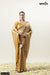 A full front view of the model in Vanya Sarees' regal mustard gold Banarasi silk saree with a woven chevron pattern.