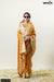 Model wearing sunglasses in a full front view of Vanya Sarees' mustard yellow woven tissue silk saree with a designer jacket blouse.