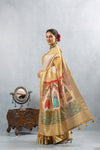 An elegant side profile of the model in the Vanya Sarees off-white silk saree, showcasing the full grandeur of the puppet-print pallu.