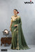 A full-length view of the model in Vanya Sarees' elegant olive green crushed tissue silk saree with a designer appliqué blouse.