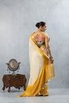 A full back view of the model in the Vanya Sarees ensemble, displaying the drape of the ombre pallu over the artistic Kathputli blouse.
