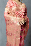 Detailed close-up of Vanya's Peach Saree pallu, showing the Gold Zari weave, maroon embroidered motifs, and tassels.
