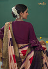 The stunning back view of the Vanya Sarees ensemble, displaying the drape of the Banarasi pallu and the purple designer bell sleeve blouse.