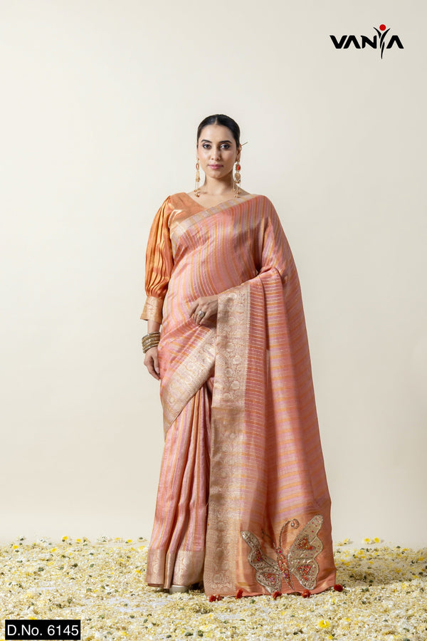 A full view of the model in Vanya Sarees' enchanting peach striped tissue silk saree with butterfly appliqué.