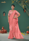 An graceful standing pose of the model showcasing the complete designer look of the Vanya Sarees peach heavy embroidered saree.