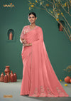 A full-length view of the model in Vanya Sarees' magnificent peach silk saree with a heavy, multi-color embroidered border.