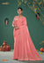 A full-length view of the model in Vanya Sarees' magnificent peach silk saree with a heavy, multi-color embroidered border.