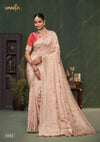 A full-length view of the model in Vanya Sarees' elegant peach pink Katan Banarasi silk saree with gold zari buttis.