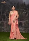 An graceful standing pose of the model showcasing the complete designer look of the Vanya Sarees peach saree and artistic embroidered blouse.