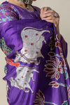 A detailed shot of the Pichwai-style sacred cow print with handprint motifs on the Vanya Sarees purple Tussar silk saree.