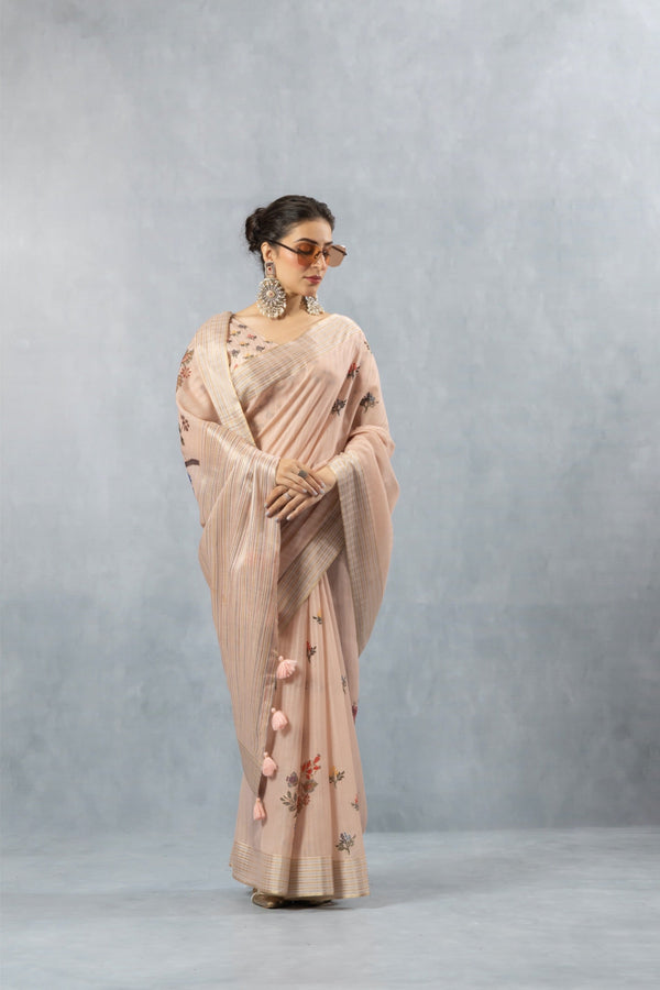 A graceful full-length pose of the model wearing the Vanya Sarees pink printed linen saree with its matching designer blouse.