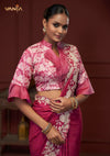 A clear close-up of the Vanya Sarees designer blouse, showing the unique high collar, floral print, and dramatic bell sleeves.