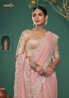 An elegant pose of the model showcasing the complete designer look of the Vanya Sarees pink heavy embroidered saree and gold blouse.