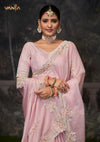 A beautiful close-up of the model in a Vanya Sarees saree, highlighting the rich, multi-color floral embroidery on the border and blouse sleeve.