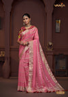 A full-length view of the model in Vanya Sarees' festive rani pink georgette saree with a multi-color Patola print collar blouse.