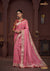 A full-length view of the model in Vanya Sarees' festive rani pink georgette saree with a multi-color Patola print collar blouse.