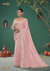 A full-length view of the model in Vanya Sarees' magnificent dusty rose saree with a heavy, scalloped mirror work border.