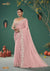 A full-length view of the model in Vanya Sarees' magnificent dusty rose saree with a heavy, scalloped mirror work border.