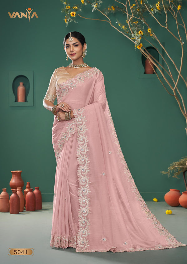 A full-length view of the model in Vanya Sarees' magnificent dusty rose saree with a heavy, scalloped mirror work border.