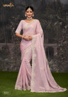 A full-length view of the model in Vanya Sarees' magnificent blush pink saree with a heavy, multi-color embroidered cutwork border.