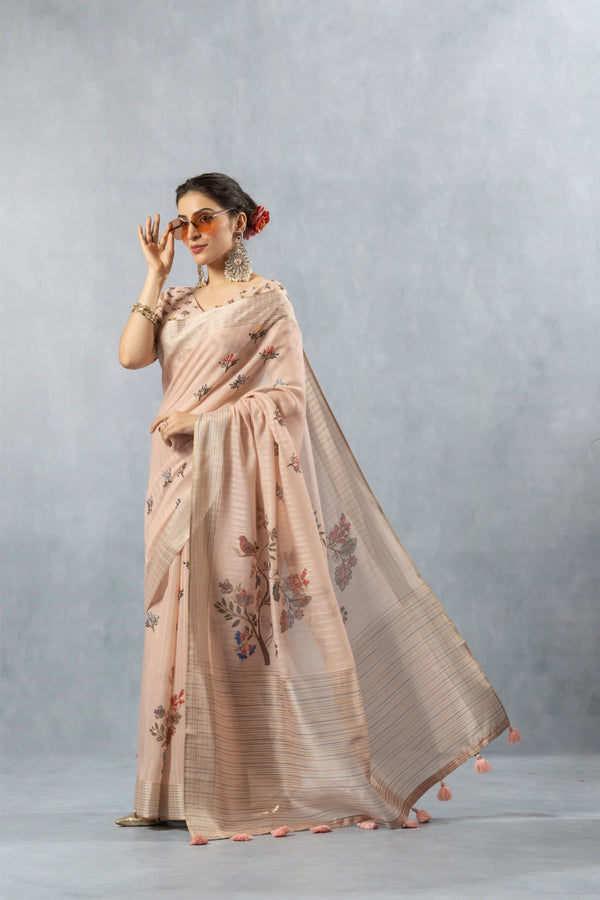 An elegant pose of the model showcasing the full designer look of the Vanya Sarees pink striped linen saree, perfect for a day wedding.