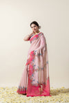 An elegant pose of the model showcasing the full drape and length of the Vanya Sarees pink bird print linen cotton saree.