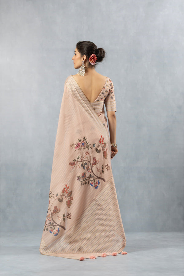 A full back view of the model in the Vanya Sarees pink linen saree, showcasing the beautiful painterly bird print on the pallu.