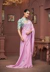 A graceful standing pose of the model showcasing the complete designer look of the Vanya Sarees pink saree and high-neck floral blouse.