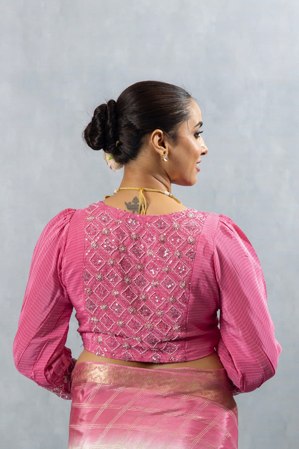 The heavily embellished back of the pink designer blouse from Vanya Sarees, showcasing the intricate sequin work in a diamond pattern.