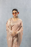 A stylish close-up of the model in sunglasses, wearing the Vanya Sarees pink striped linen saree.